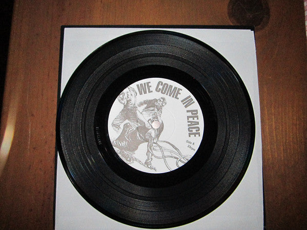 Various : We Come In Peace (More World, Less Bank! Pt.2) (7",33 ⅓ RPM)